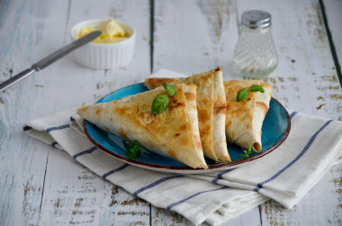 Lavash envelopes with different fillings on frying pan