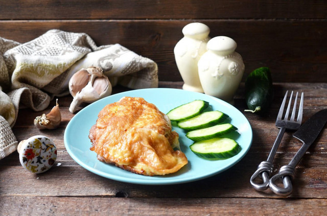 Chicken breast in batter in a frying pan