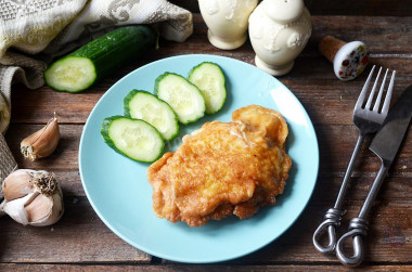 Chicken breast in batter in a frying pan