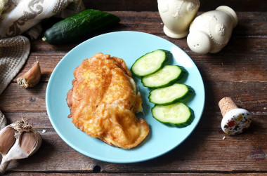 Chicken breast in batter in a frying pan