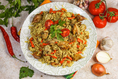 Crumbly pilaf with chicken in a saucepan on the stove