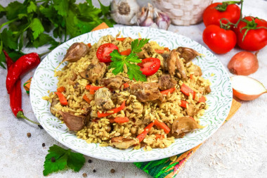 Crumbly pilaf with chicken in a saucepan on the stove