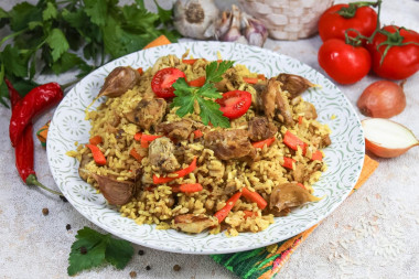 Crumbly pilaf with chicken in a saucepan on the stove