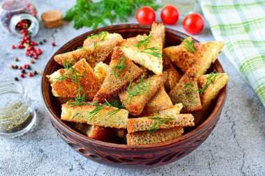 Croutons with garlic in a frying pan