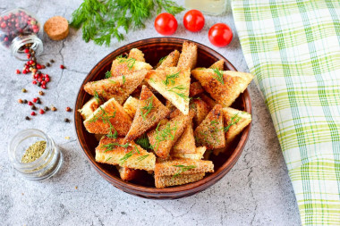 Croutons with garlic in a frying pan