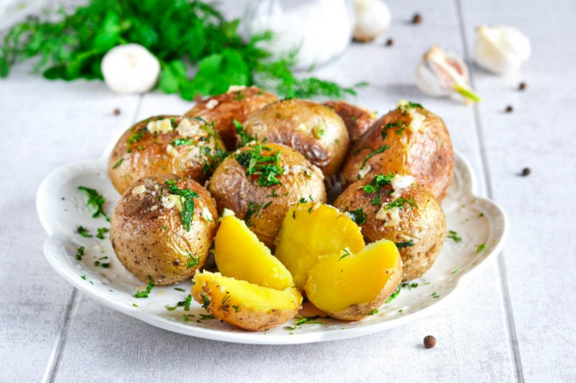 Whole new potatoes in a frying pan in the peel