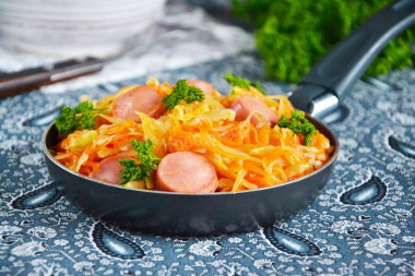 Stewed cabbage with sausages in a frying pan