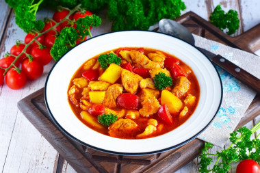 Chicken goulash with tomato sauce in a frying pan