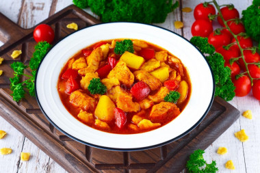 Chicken goulash with tomato sauce in a frying pan