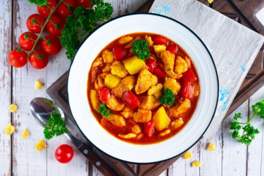 Chicken goulash with tomato sauce in a frying pan