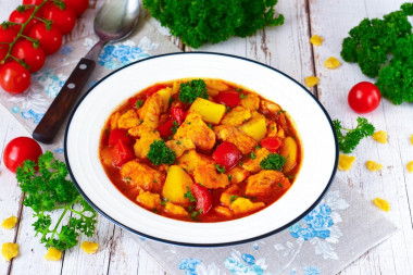 Chicken goulash with tomato sauce in a frying pan