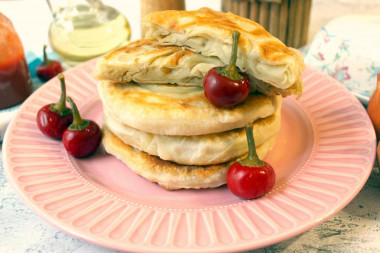 Puff pastry in a frying pan with onions