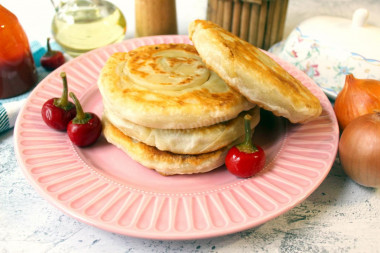 Puff pastry in a frying pan with onions