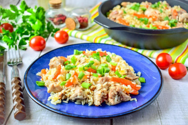 Rice with chicken in a frying pan