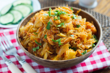 Stewed cabbage with potatoes in a frying pan