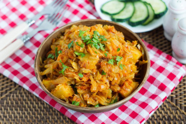 Stewed cabbage with potatoes in a frying pan