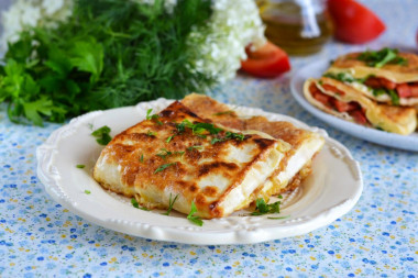 Pita bread with cheese and tomatoes in a frying pan