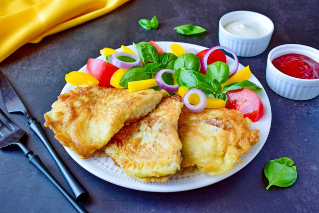 Tilapia in a frying pan in batter