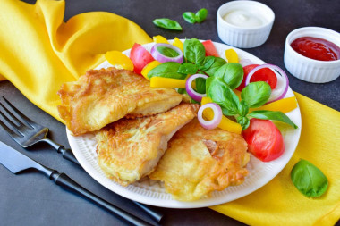 Tilapia in a frying pan in batter