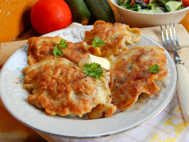 Chicken fillet chops in a frying pan in batter