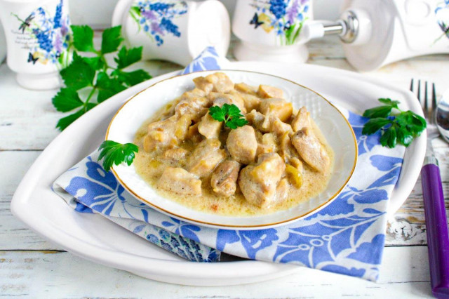 Chicken fillet in sour cream sauce in a frying pan