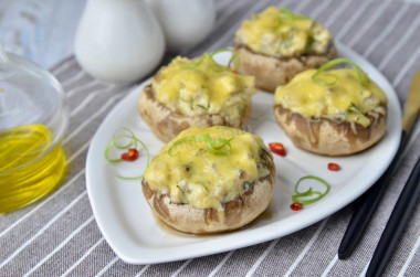 Mushrooms stuffed with chicken and cheese in the oven