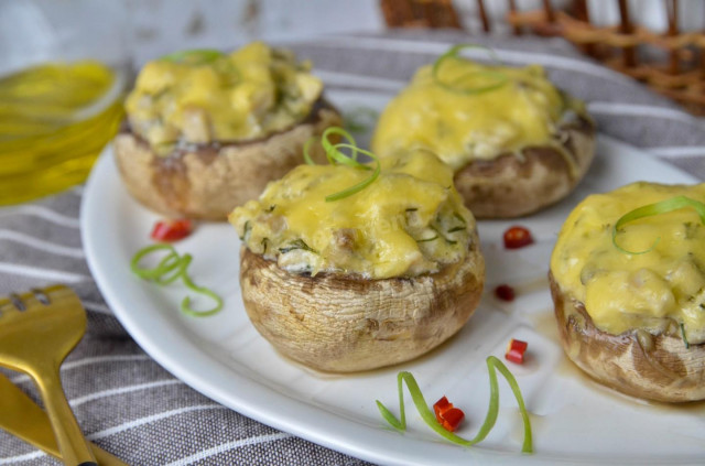 Mushrooms stuffed with chicken and cheese in the oven