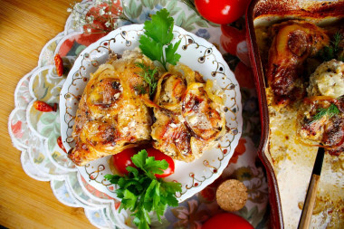 Rabbit stewed in sour cream in the oven