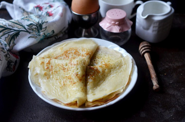 Custard pancakes with holes in boiling water and milk