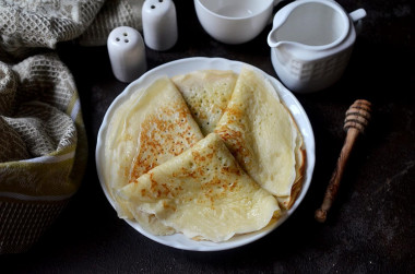 Custard pancakes with holes in boiling water and milk