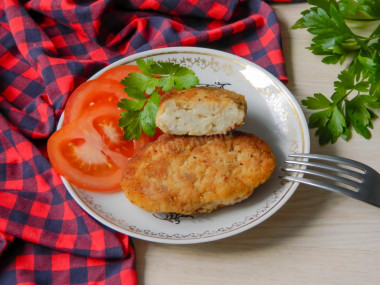 Pike fish cutlets with bacon in a frying pan