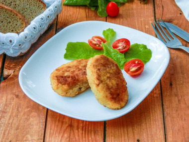 Pike fish cutlets with bacon in a frying pan