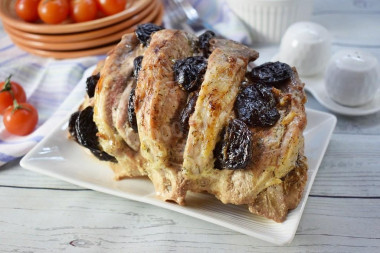 Pork with prunes in marinade in the oven in foil