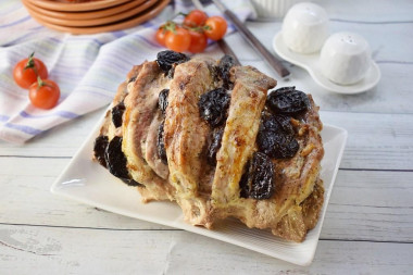 Pork with prunes in marinade in the oven in foil