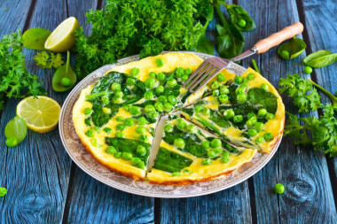 Omelet with spinach in a frying pan