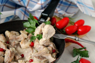 Pork in cream sauce in a frying pan