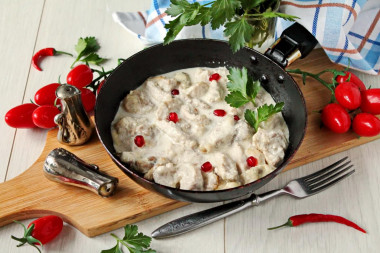 Pork in cream sauce in a frying pan