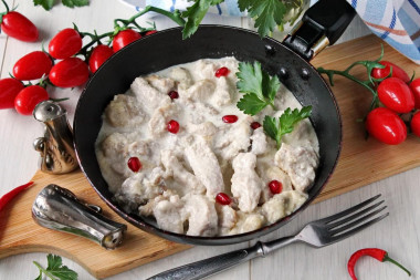 Pork in cream sauce in a frying pan