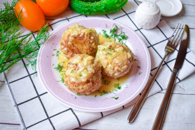 Meatballs with sour cream in a frying pan