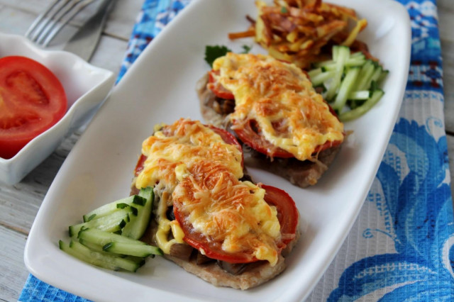 Pork mushrooms tomatoes cheese in the oven