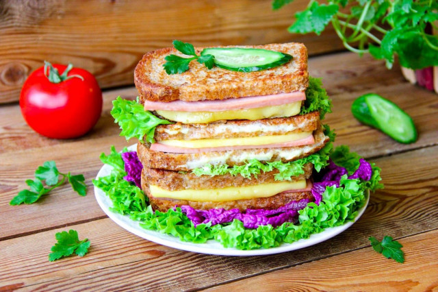 Sandwiches in a frying pan with sausage and cheese