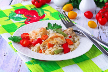 Rice with chicken breast and vegetables in the oven