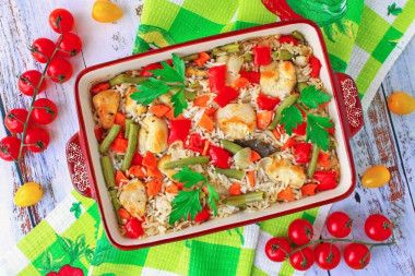 Rice with chicken breast and vegetables in the oven