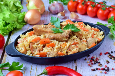 Crumbly pilaf with pork in a frying pan