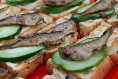 Sandwiches with mayonnaise sprats tomato and cucumber