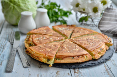 Cabbage filling pie with cabbage in a frying pan