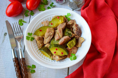 Pork with zucchini stewed in a frying pan