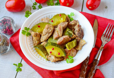 Pork with zucchini stewed in a frying pan