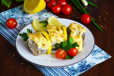 Pollock in the oven with mayonnaise and onions