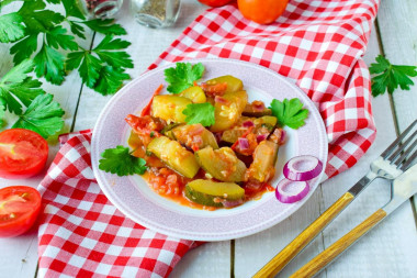 Stewed zucchini with tomatoes and garlic in a frying pan